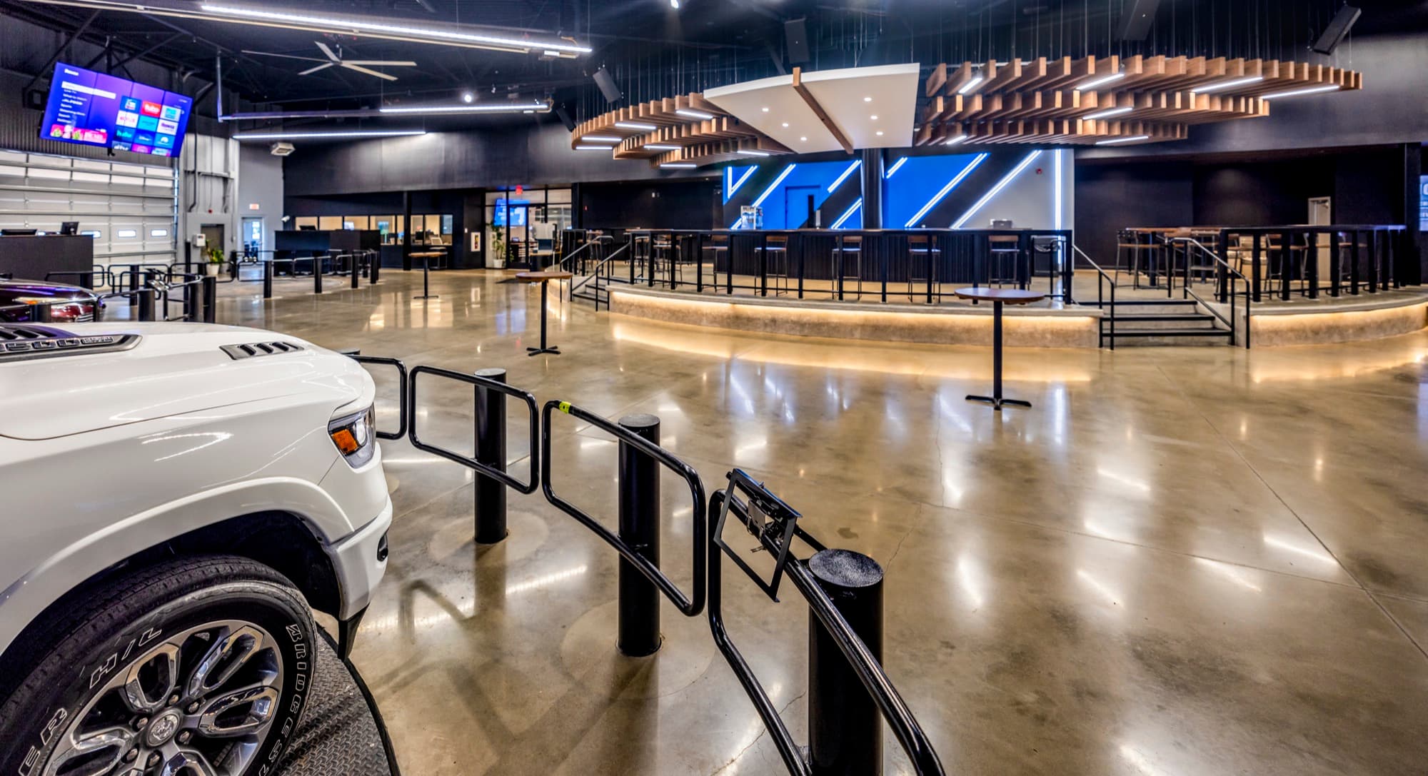 Wide view of the UAX auction floor — sale lanes, bar, signature ceiling.